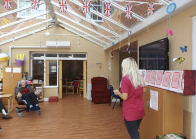 Princess Christian Care Home residents playing a giant card game in their conservatory