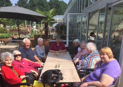A group of residents around a table at a Garden Centre