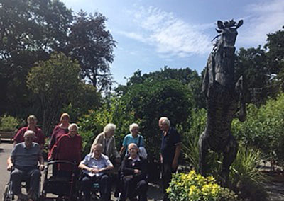 A group of residents in a sculptured garden