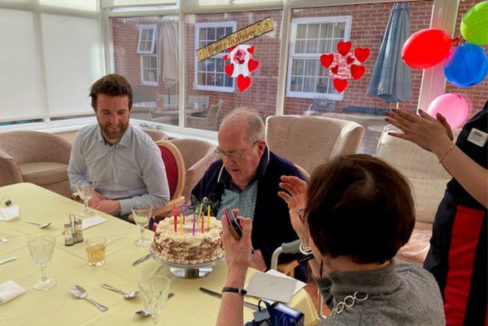 Gentleman resident at Princess Christian Care Home receiving his birthday cake