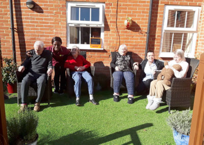 Princess Christian residents sitting in the sunny garden