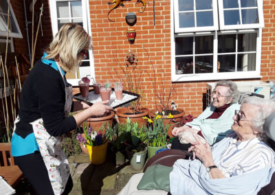 Princess Christian residents sitting in the sunny garden with a smoothie