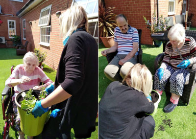 Residents potting plants in the Bisley Unit courtyard garden at Princess Christian Care Home