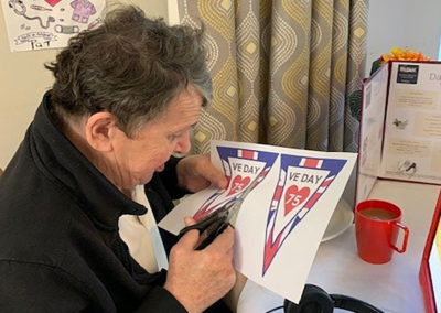 Resident cutting out Union Jack bunting