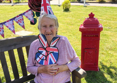 Princess Christian Care Home resident enjoying the sunny front garden on VE Day 2020