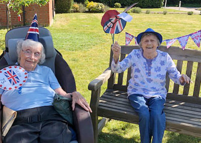 Two Princess Christian Care Home residents enjoying the sunny front garden on VE Day 2020