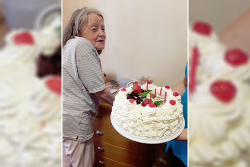 Princess Christian Care Home resident receiving a birthday cake with candles