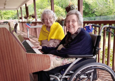 Princess Christian lady residents playing the piano together