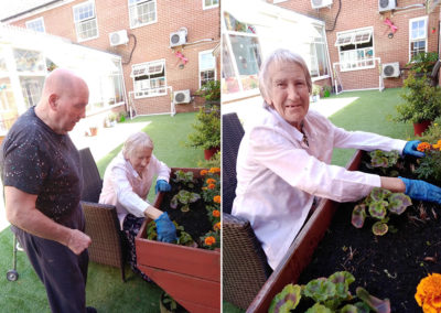 Lady resident planting in a raised bed at Princess Christian
