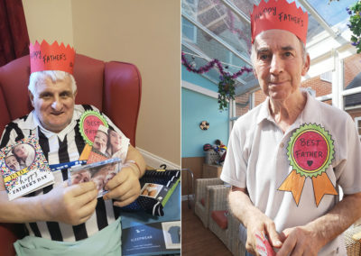 Two gentlemen residents wearing Father's Day hats and rosettes at Princess Christian