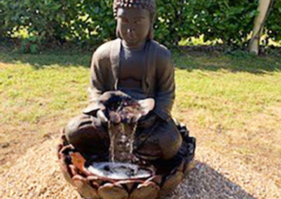 A Buddha water feature in the garden at Princess Christian Care Home