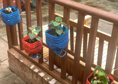 Hanging flower pots in the garden at Princess Christian Care Home