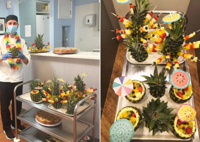 Chef standing with an array of tropical themed fruit displays
