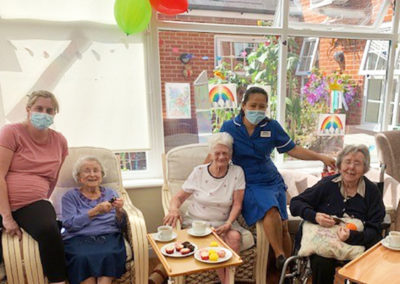 Lady resident at Princess Christian Care Home celebrating her birthday with tea and cakes