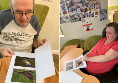 Princess Christian Care Home residents looking at bird photographs in books