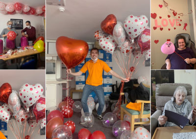 Staff member with Valentine helium balloons at Princess Christian Care Home