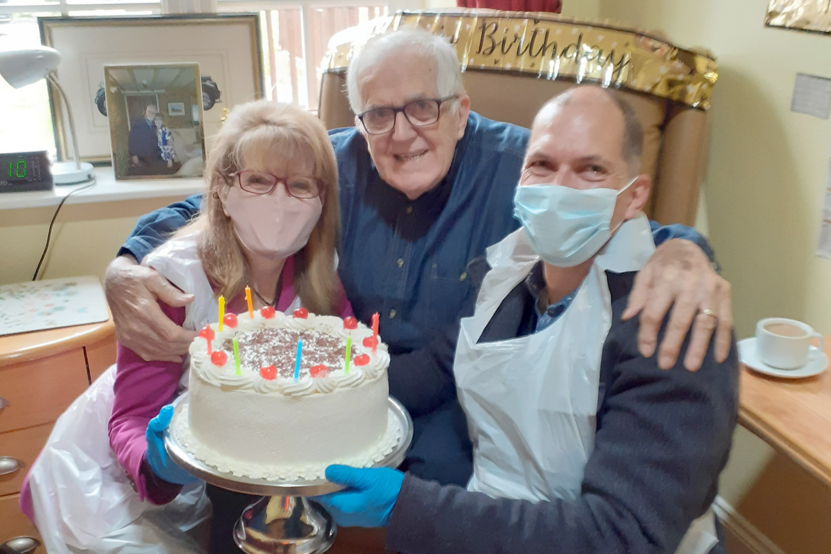 Princess Christian Care Home resident with his family members and birthday cake